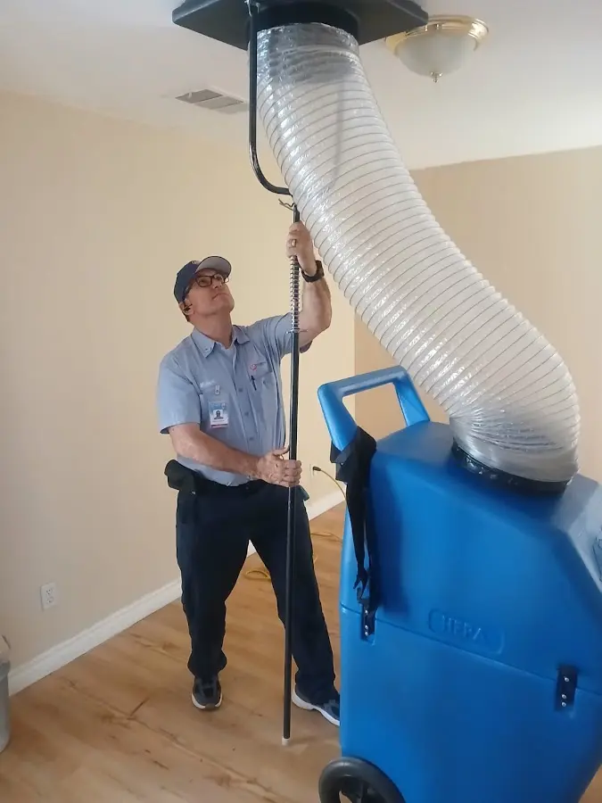 Furnace Tune-Up technician using HEPA equipment in Longmont